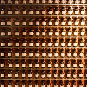rows of fragrance bottles on shelves